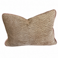 A rectangular decorative throw pillow with a textured geometric Greek key pattern in beige and brown, featuring a solid brown border, shown on a plain white background.